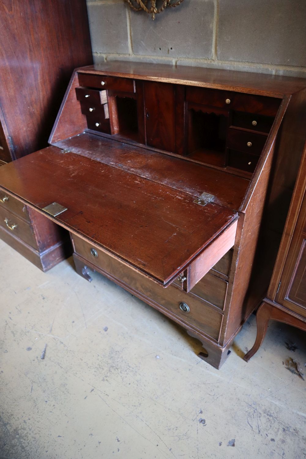 A George III mahogany bureau, fitted four long drawers, width 99cm